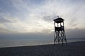 Lifeguard tower on beach at daytime with blue sky and wavy sea background. Royalty Free Stock Photo