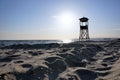 Lifeguard tower on beach at daytime with blue sky and wavy sea background. Royalty Free Stock Photo