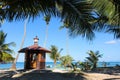 Lifeguard tower on the coconut beach. The clock tower, Hut or Cottage against the blue sky Royalty Free Stock Photo