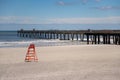 Lifeguard tower at empty Jacksonville Beach FL closed Coronavirus Covid 19 pandemic focus on chair Royalty Free Stock Photo