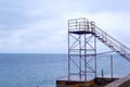 Lifeguard tower at empty waterfront beach in the off-season. Windy day and stormy sea. Royalty Free Stock Photo