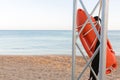 Lifeguard tower with orange buoy on the beach. rescue buoy on the iron rescue post Royalty Free Stock Photo