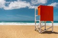 Lifeguard tower on sandy beach with sea background Royalty Free Stock Photo