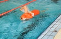 Lifeguard training with rescue dummy in a pool