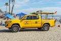 Lifeguard truck parked on the raked sand at the Oceanside beach, San Diego, California, USA.