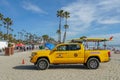 Lifeguard truck parked on the raked sand at the Oceanside beach, San Diego, California, USA.