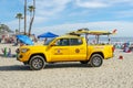 Lifeguard truck parked on the raked sand at the Oceanside beach, San Diego, California, USA.