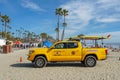 Lifeguard truck parked on the raked sand at the Oceanside beach, San Diego, California, USA.