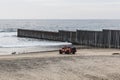 Lifeguard Vehicle Waits on Beach Near International Border Wall in Mexico Royalty Free Stock Photo