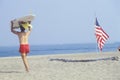 Lifeguard walking past an American flag