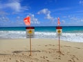 Lifeguard warning sign place in the sand on the beach warning of Man-O-War and Strong Current