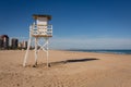 Lifeguard watch tower on empty beach with Gandia in background Royalty Free Stock Photo