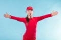 Lifeguard woman in cap on duty blowing whistle.