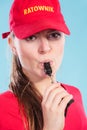 Lifeguard woman in cap on duty blowing whistle. Royalty Free Stock Photo