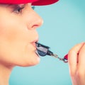 Lifeguard woman in cap on duty whistling. Royalty Free Stock Photo