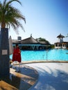 Lifeguard woman on chair at pool outdoor