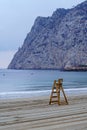 Lifeguard wooden chair next to large cliff. Calpe Alicante.