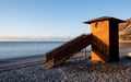 Lifeguard wooden tower at sunrise. Empty beach Pissouri Cyprus