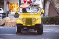 Lifeguard yellow Jeep with a surfboard on top at Laguna Beach, California