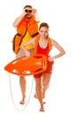 Lifeguards in life vest with rescue buoy running