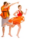 Lifeguards in life vest with rescue buoy running