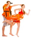 Lifeguards in life vest with rescue buoy running