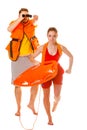 Lifeguards in life vest with rescue buoy running
