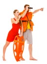 Lifeguards in life vest with rescue buoy whistling