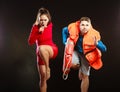 Lifeguards in life vest with ring buoy whistling. Royalty Free Stock Photo