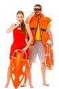 Lifeguards in life vest with ring buoy whistling. Royalty Free Stock Photo