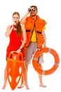 Lifeguards in life vest with ring buoy whistling. Royalty Free Stock Photo
