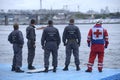 Lifeguards and paramedic standing on a pier waiting for sufferers. Rescue operations Royalty Free Stock Photo