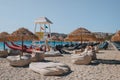 Lifeguards relaxing by the station on Kalafati beach, Mykonos, Greece, on a quiet sunny summer day