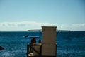 Lifeguards sit on the beach and watch tourists swimming in the sea, ocean. Safety behavior on the beach on vacation. Sunny day on Royalty Free Stock Photo