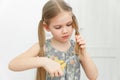 Little girl cutting hair to herself with scissors Royalty Free Stock Photo