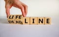 Lifeline or deadline symbol. Businessman turns wooden cubes and changes the word `deadline` to `lifeline` on a beautiful white Royalty Free Stock Photo