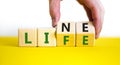 Lifeline, line of life symbol. Businessman hand turns cubes and changes the word `life` to `line`. Beautiful white background. Royalty Free Stock Photo