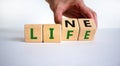 Lifeline, line of life symbol. Businessman hand turns cubes and changes the word `life` to `line`. Beautiful white background. Royalty Free Stock Photo