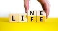 Lifeline, line of life symbol. Businessman hand turns cubes and changes the word `life` to `line`. Beautiful white background. Royalty Free Stock Photo