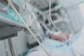 Lifelines in ICU on the background of patient in bed Royalty Free Stock Photo
