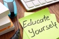 Lifelong learning. Sign educate yourself on a memo Royalty Free Stock Photo