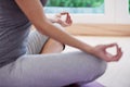 Lifes all about balance. A cropped image of a woman sitting crossed legged and meditating.