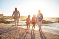 Lifes better at the beach. a grandparents enjoying a day at the beach with their granddaughters.