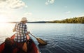 Lifes better on the water. an attractive young woman spending a day kayaking on the lake.