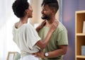 Lifes better with you in it. a young couple dancing in the living room at home.