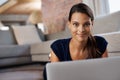 Lifes looking good. an attractive young woman using her laptop while relaxing on the floor at home. Royalty Free Stock Photo