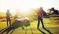 Lifes a pitch, and then you putt. two friends playing a round of golf out on a golf course. Royalty Free Stock Photo