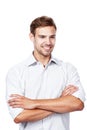 Lifes pretty good at the moment. Studio shot of a young man standing with his arms crossed against a white background. Royalty Free Stock Photo