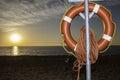 Lifesaver buoyancy aid on beach at sunrise