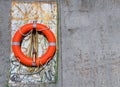 Lifesaver Hanging on Concrete Wall Royalty Free Stock Photo